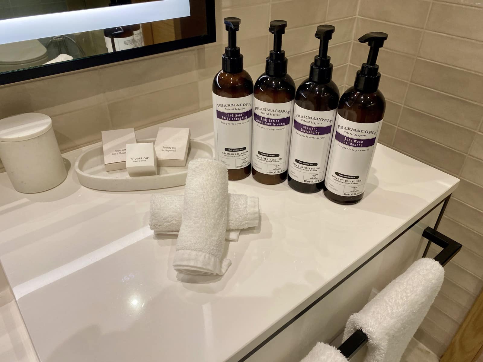 a group of bottles of soap and towels on a counter