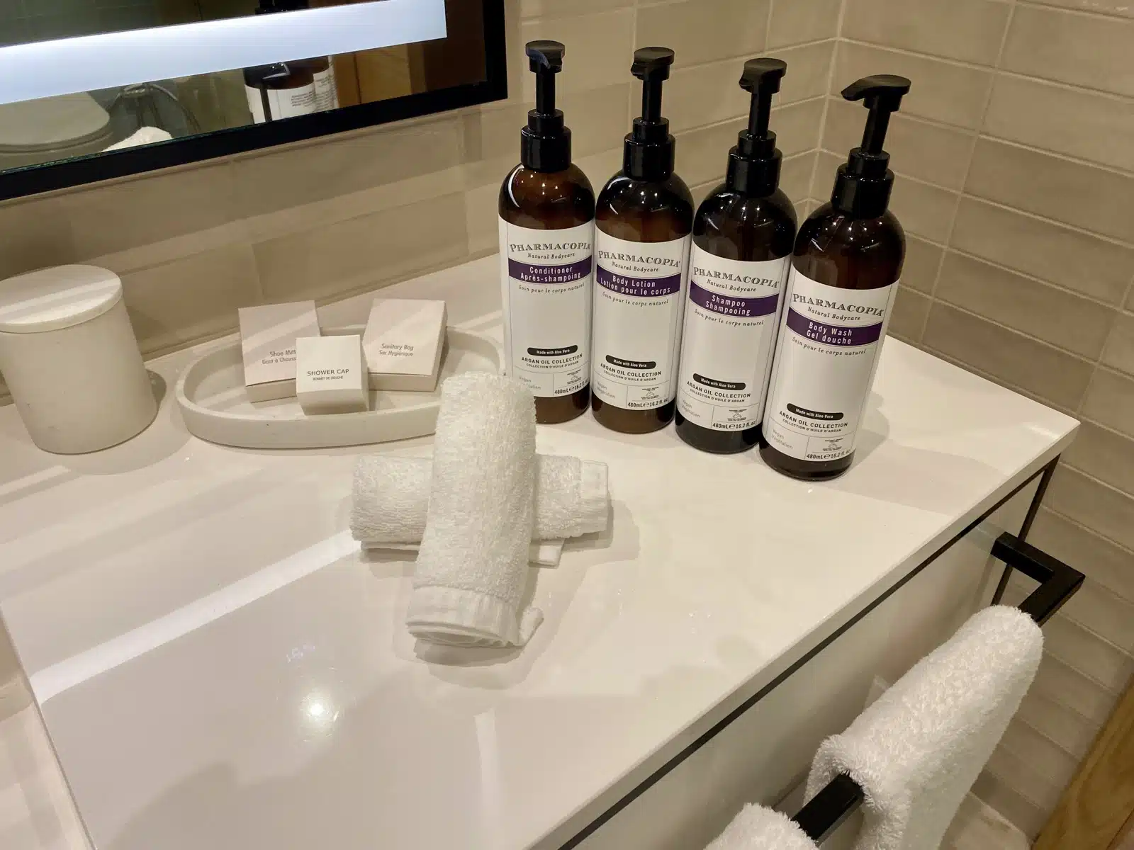 a group of bottles of soap and towels on a counter