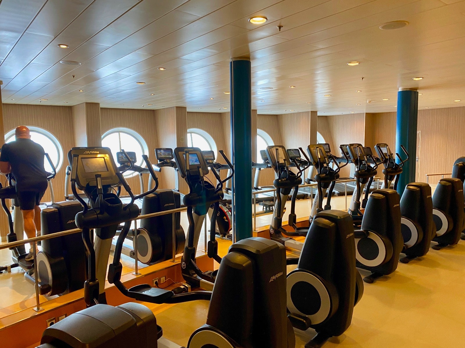 a room with exercise machines and windows