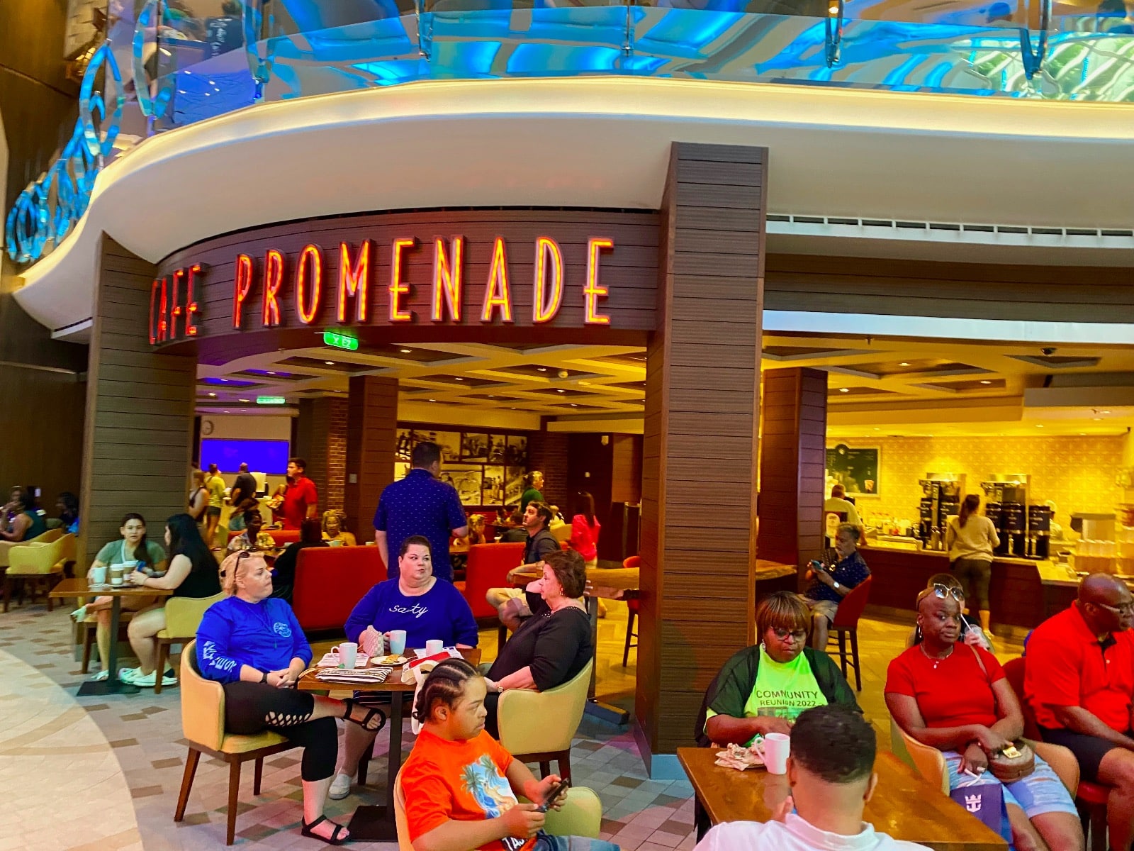 a group of people sitting at tables in a restaurant