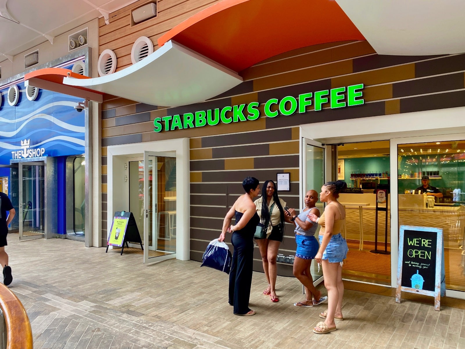 a group of women standing outside of a store