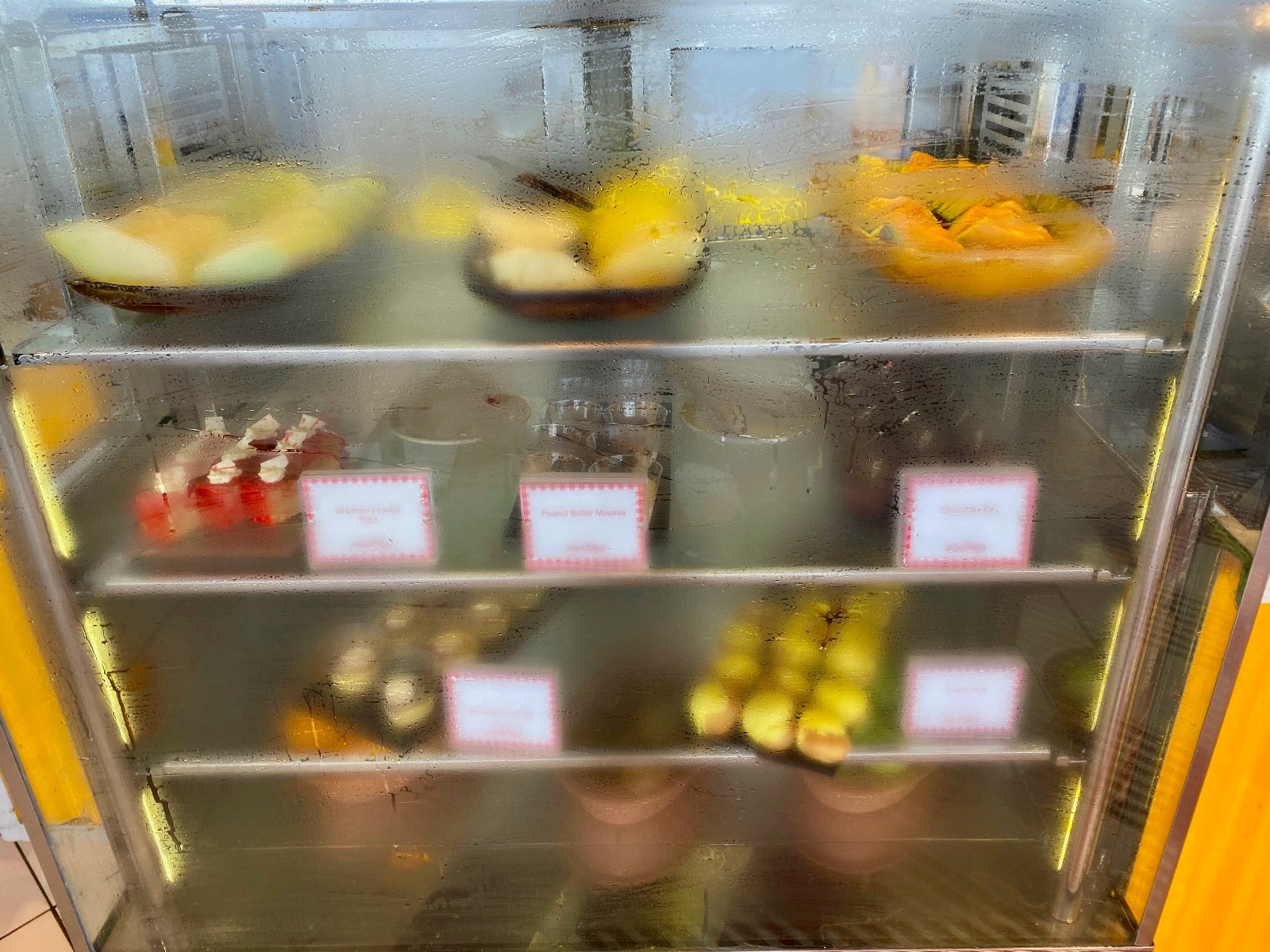 a glass case with food on it