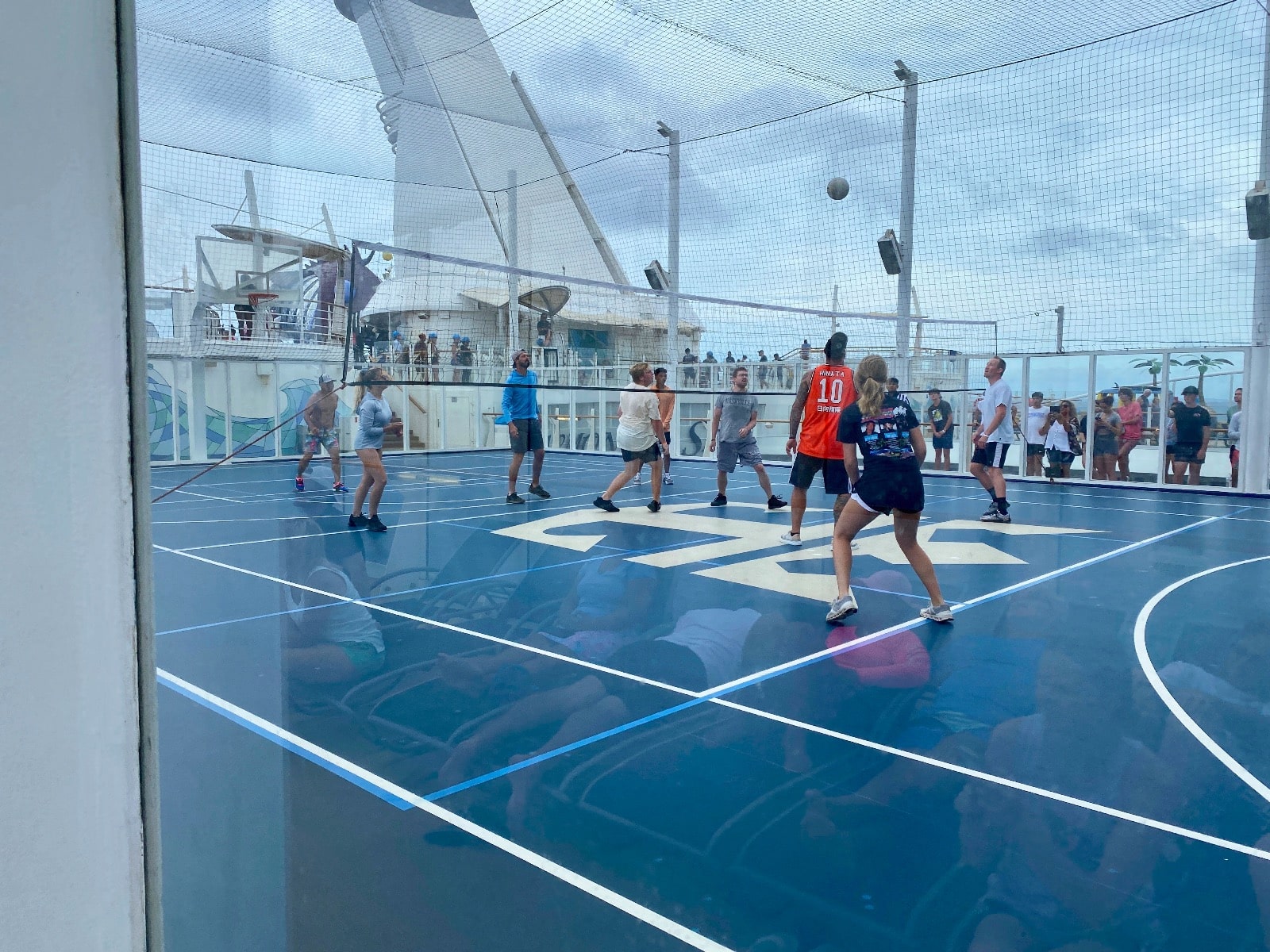 a group of people playing volleyball on a ship