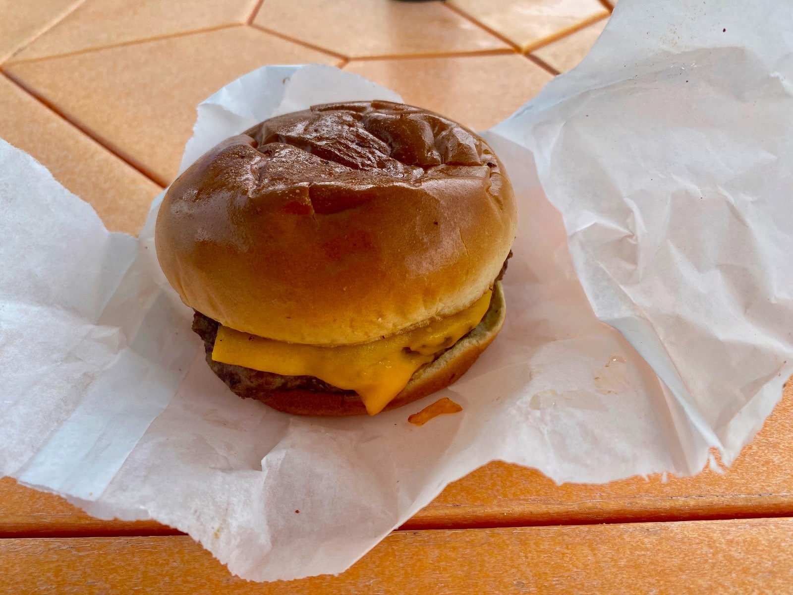 a cheeseburger on a paper wrapper