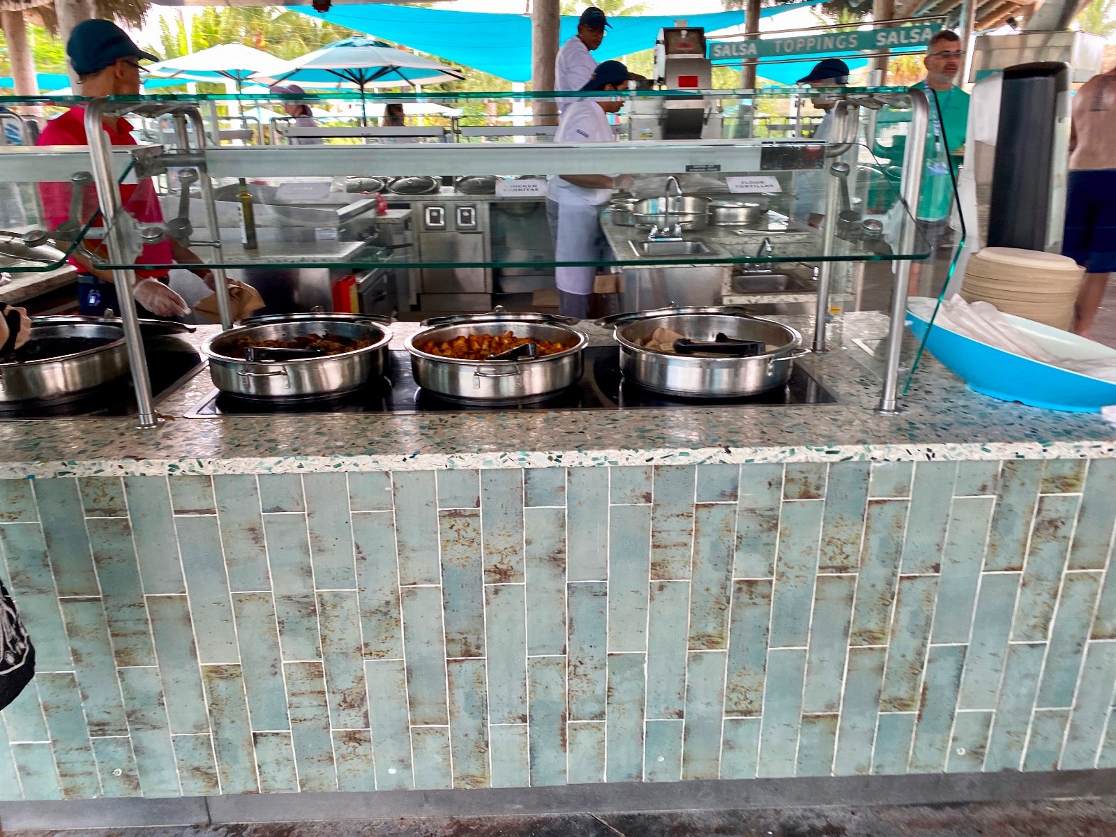 a food buffet with people in the background