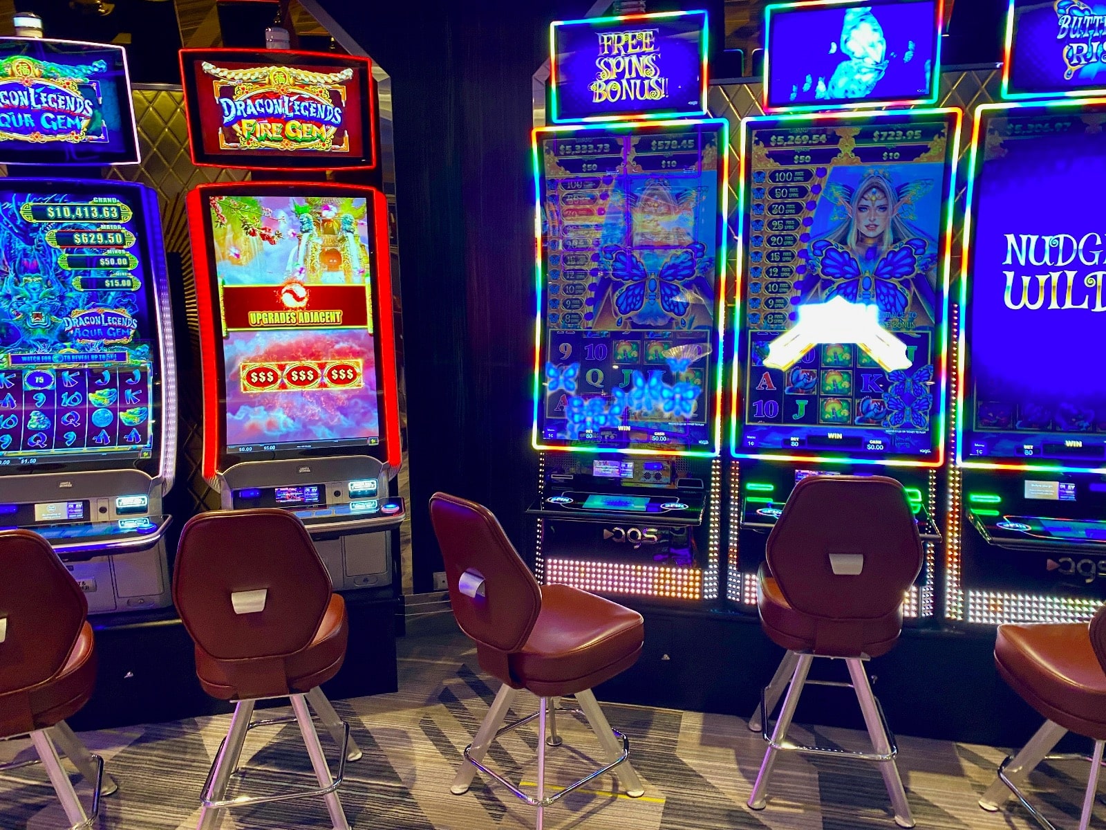 a room with a few slot machines and chairs