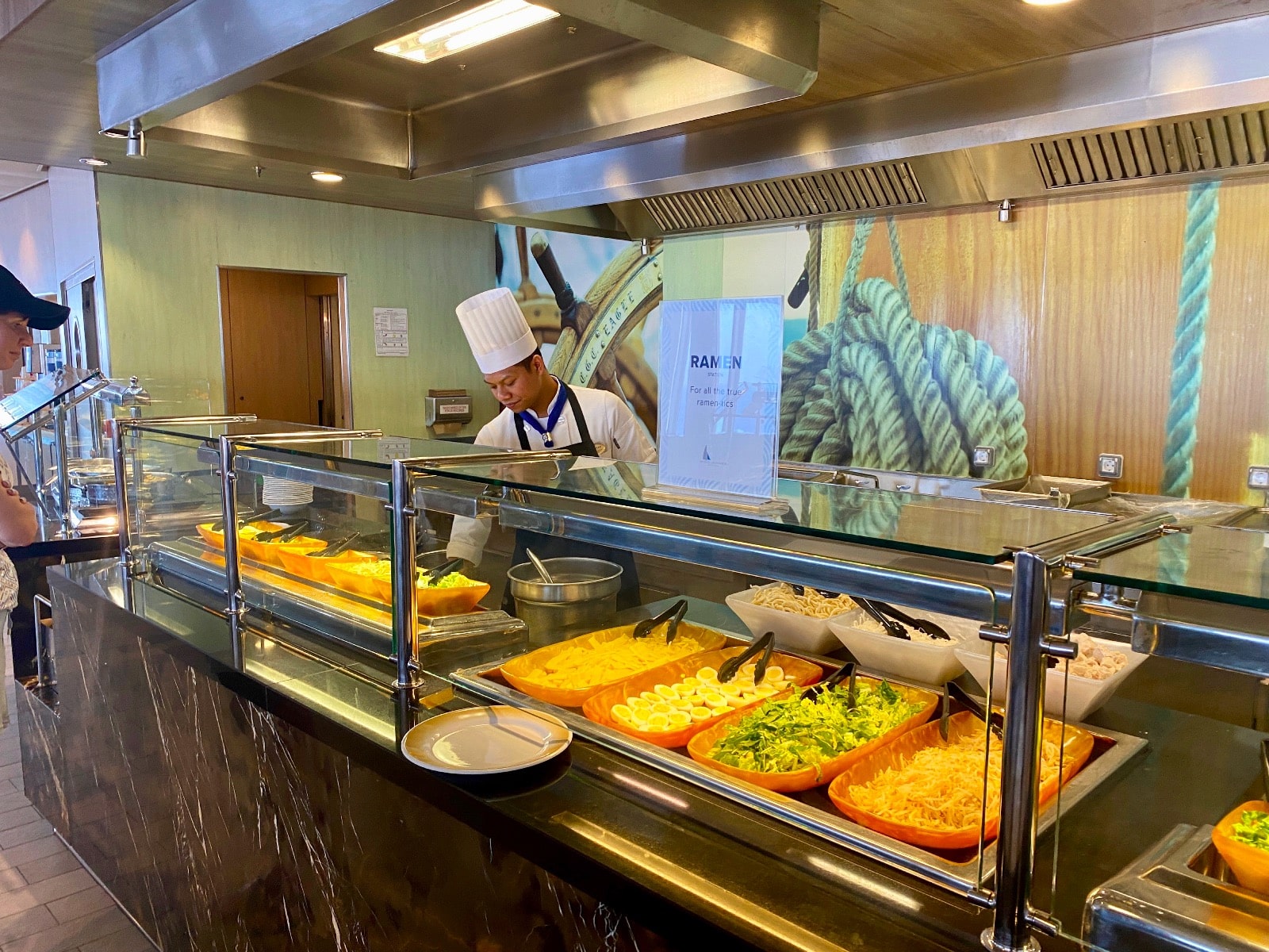 a chef behind a counter in a restaurant