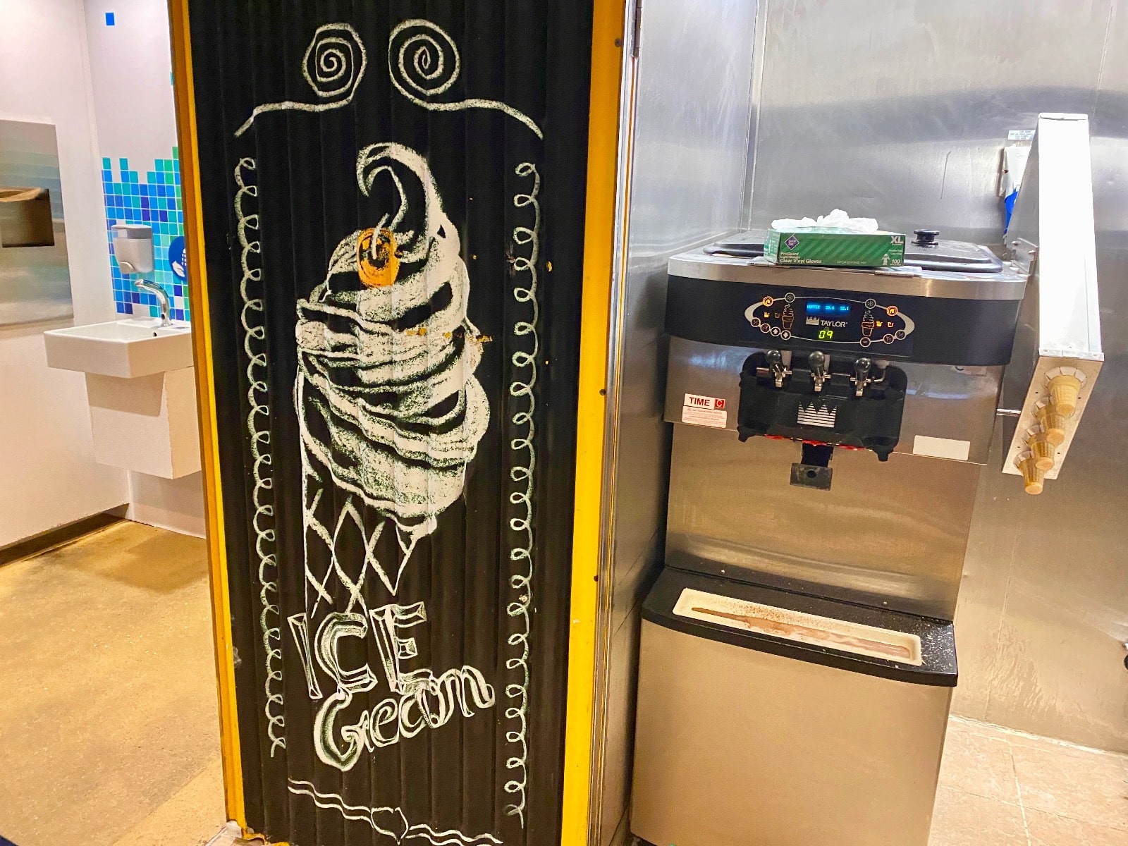 a ice cream machine next to a black and yellow door