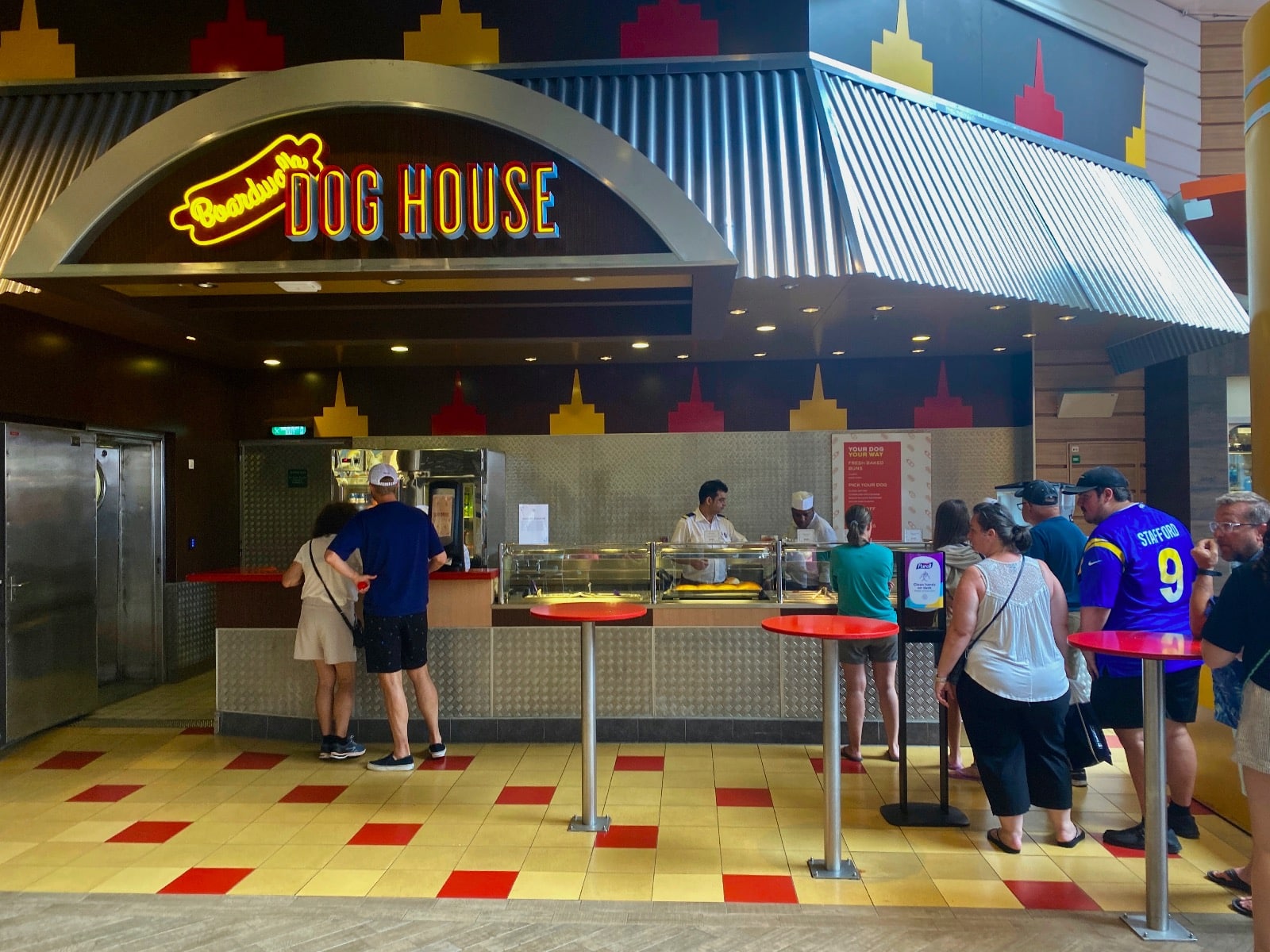 a group of people standing in front of a food stand