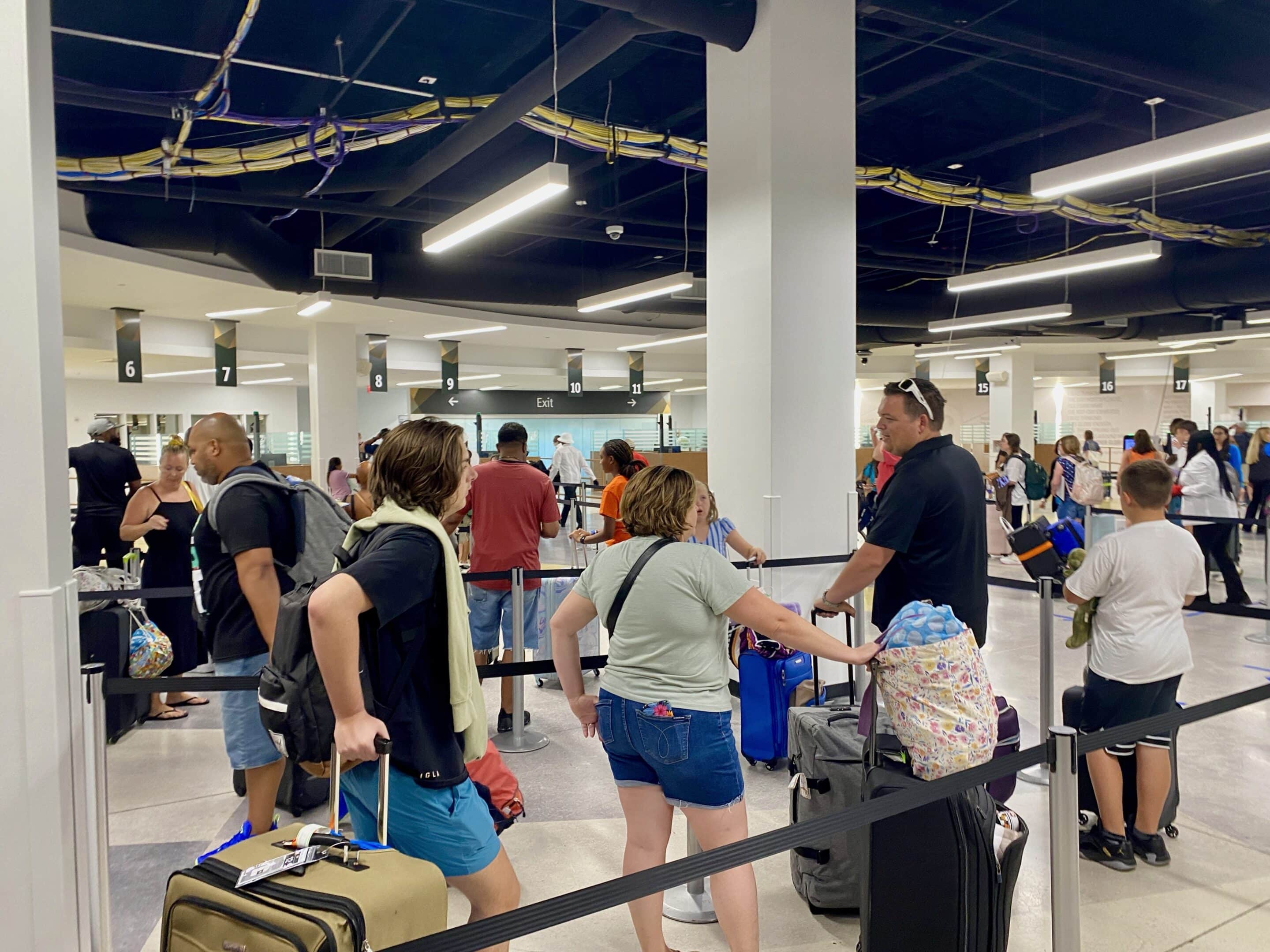 a group of people with luggage in an airport