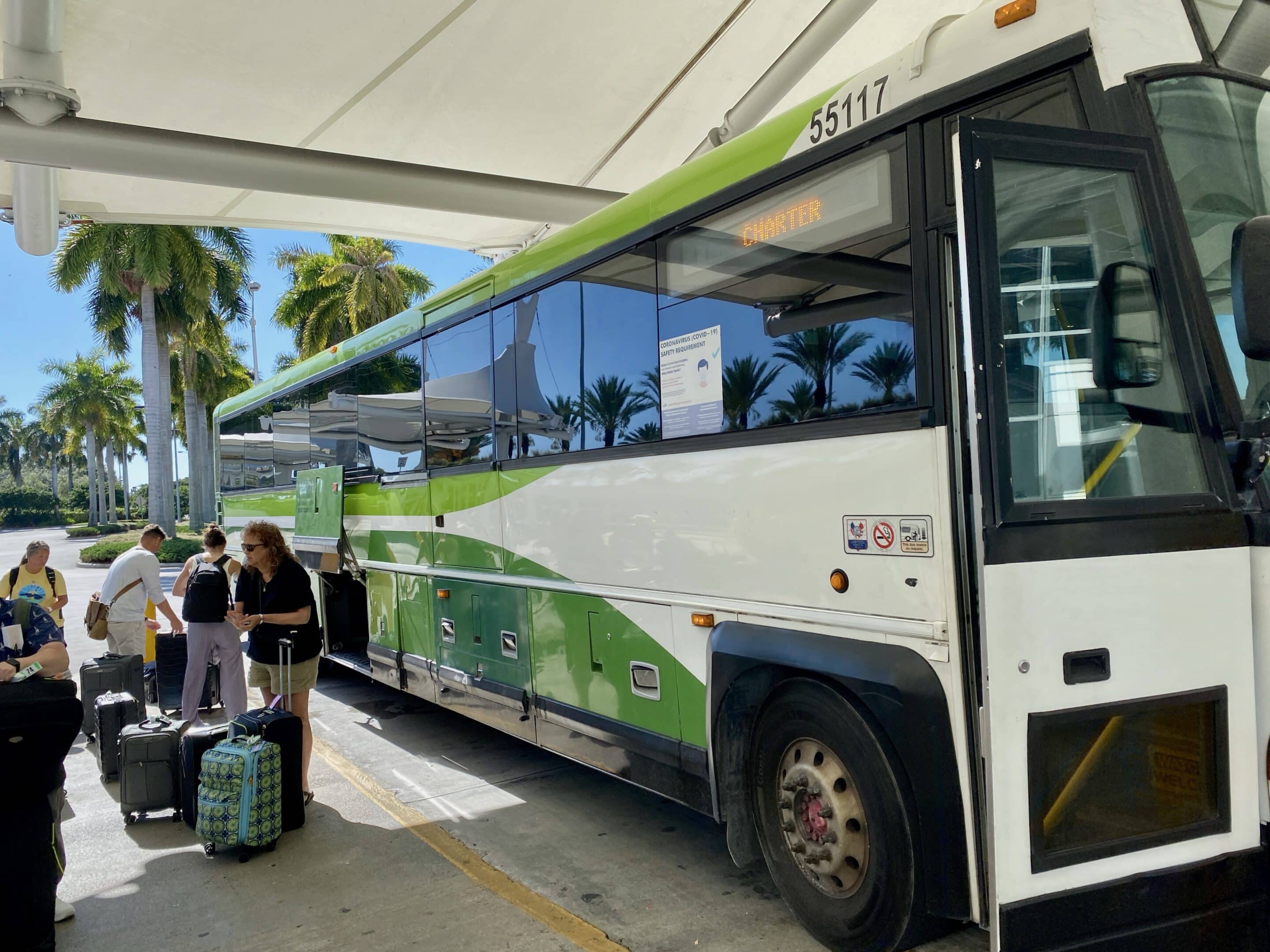 a green and white bus with luggage