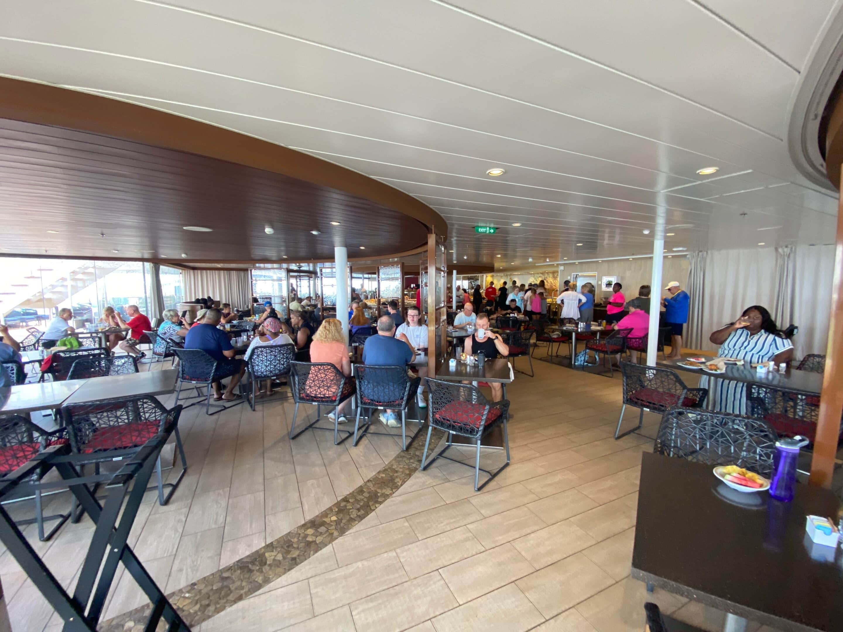 a group of people sitting at tables in a restaurant