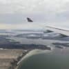an airplane wing above a body of water