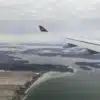 an airplane wing above a body of water