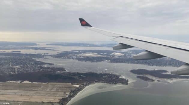 an airplane wing above a body of water
