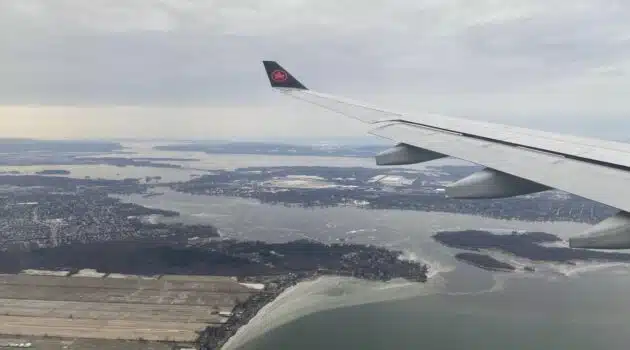 an airplane wing above a body of water
