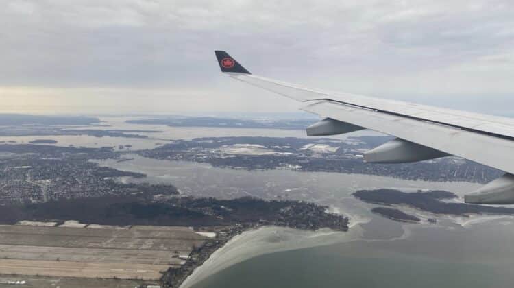 an airplane wing above a body of water