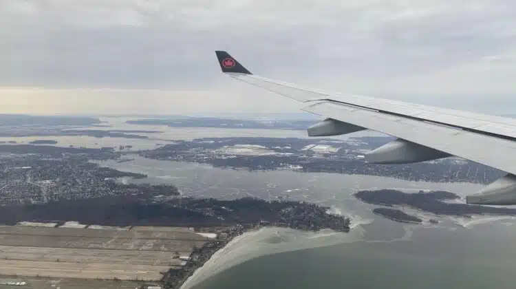 an airplane wing above a body of water