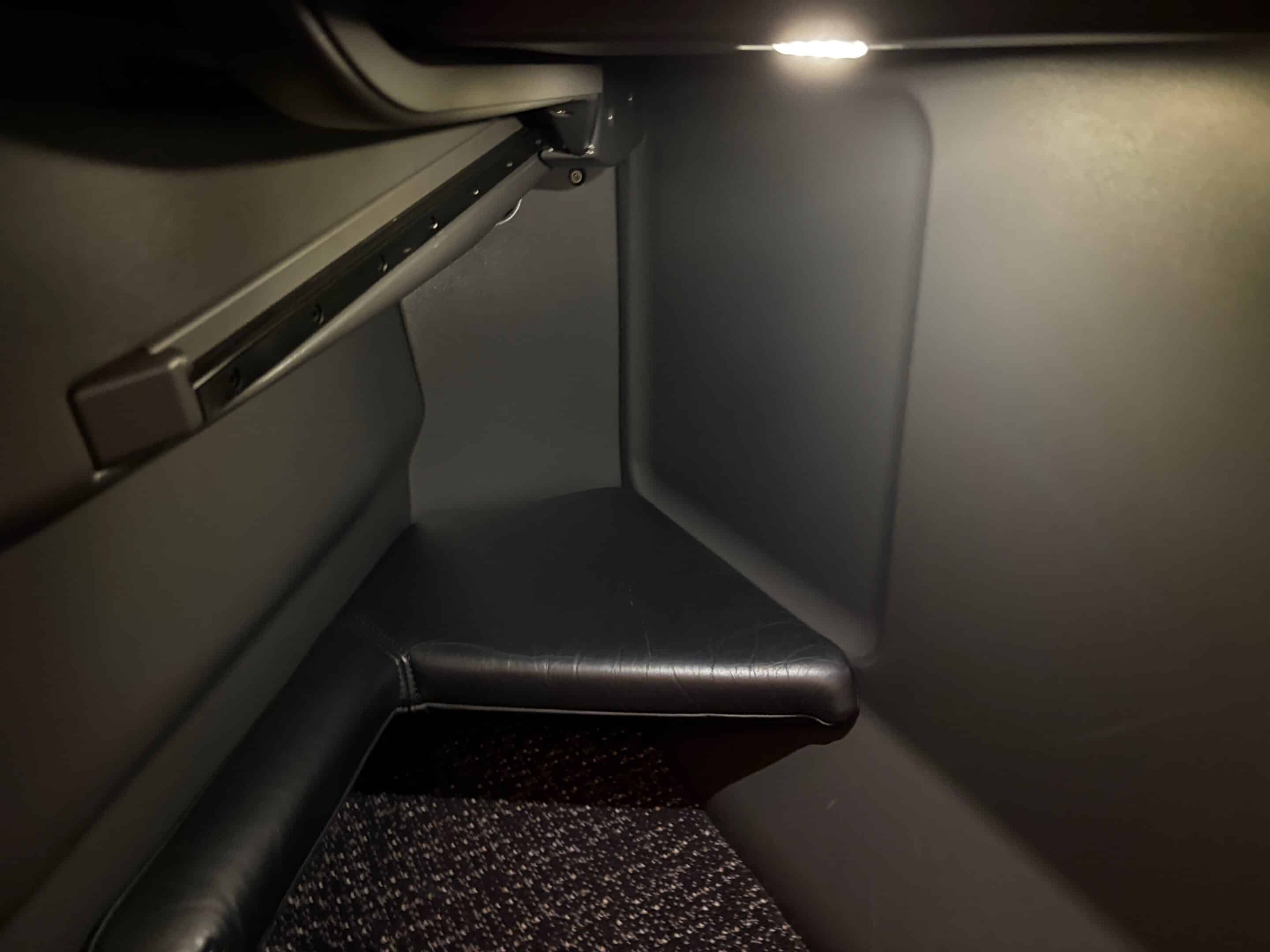 a corner of a seat with a light on it