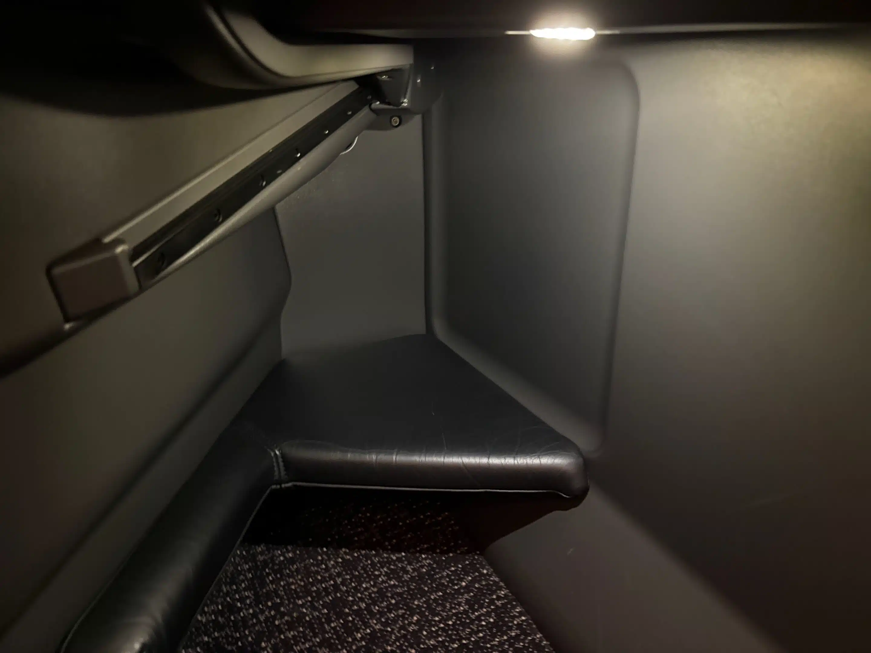 a corner of a seat with a light on it