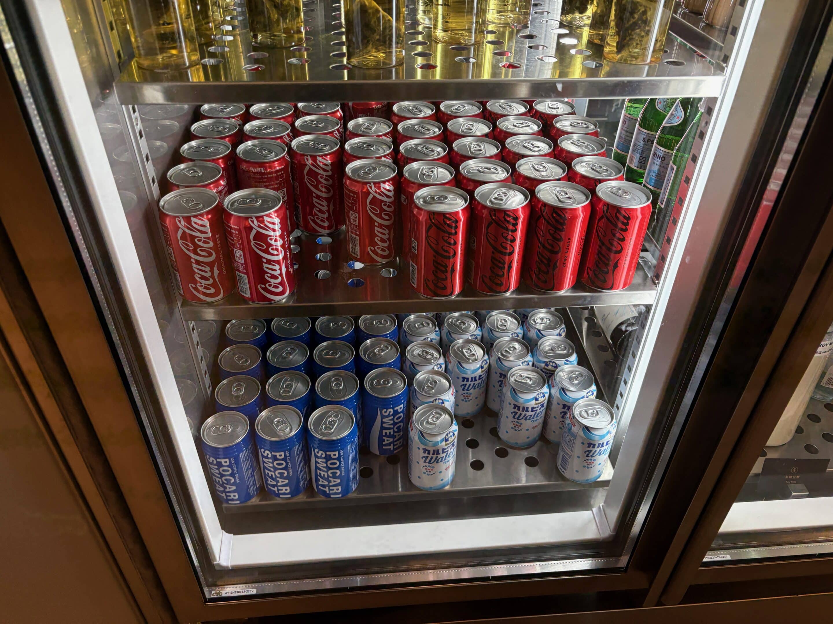 a display case with cans of soda