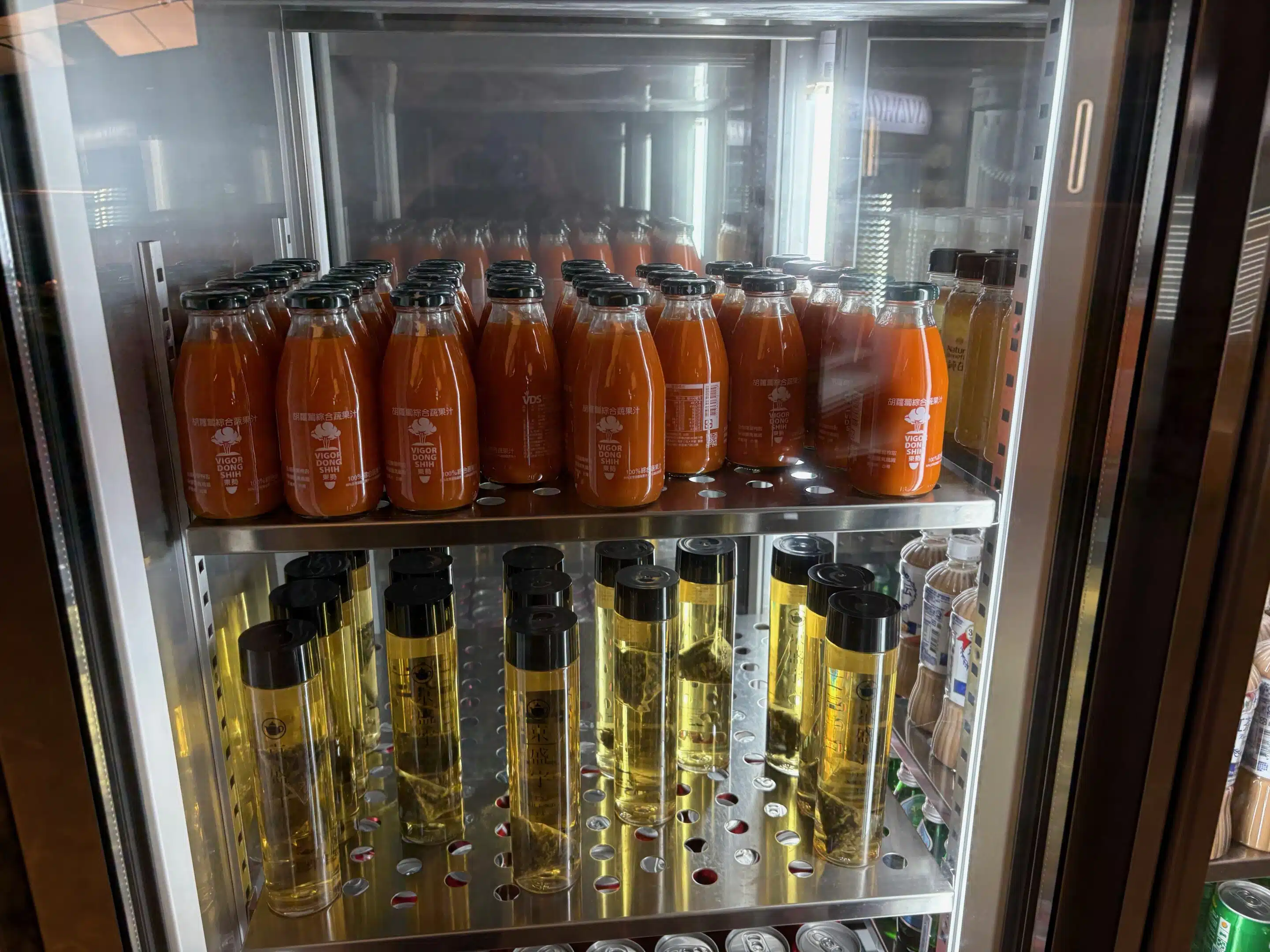 a display case with bottles of liquid