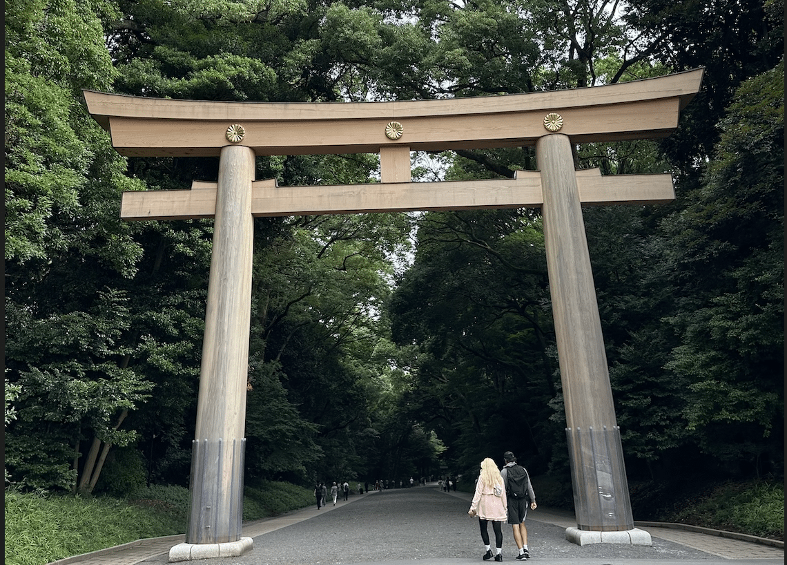 a large wooden arch over a road with people walking