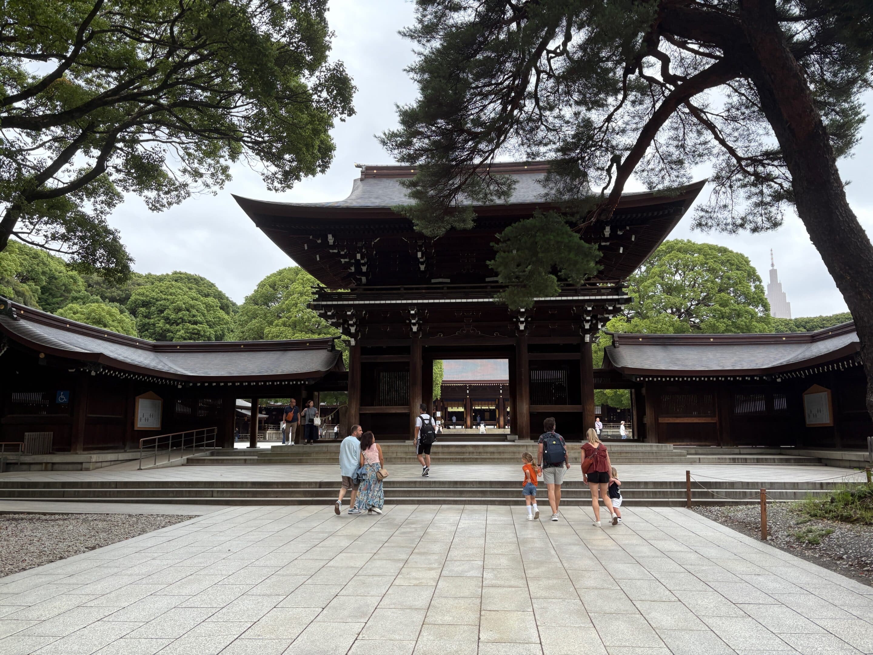 a group of people walking in front of Meiji Shrine
