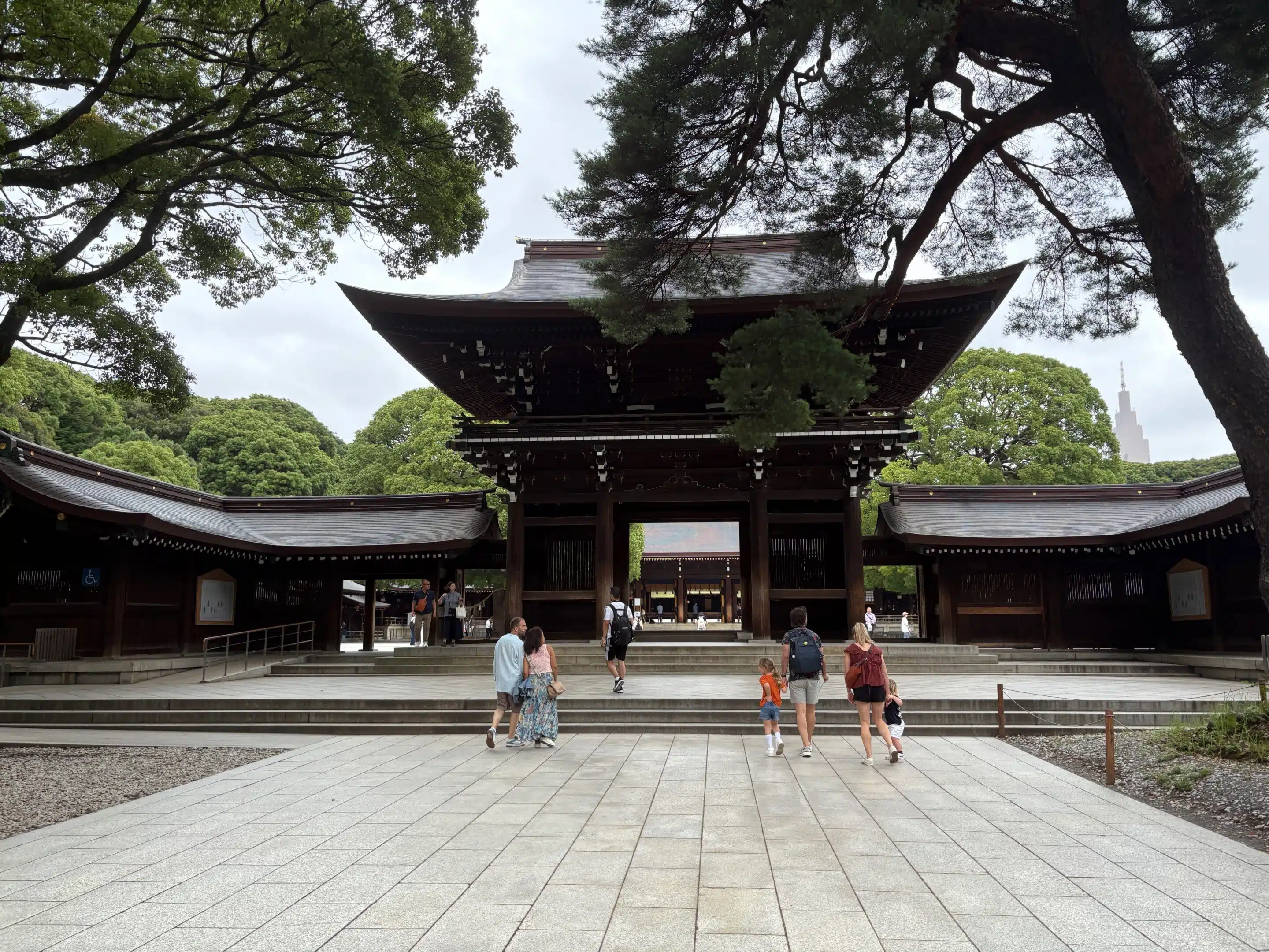a group of people walking in front of Meiji Shrine