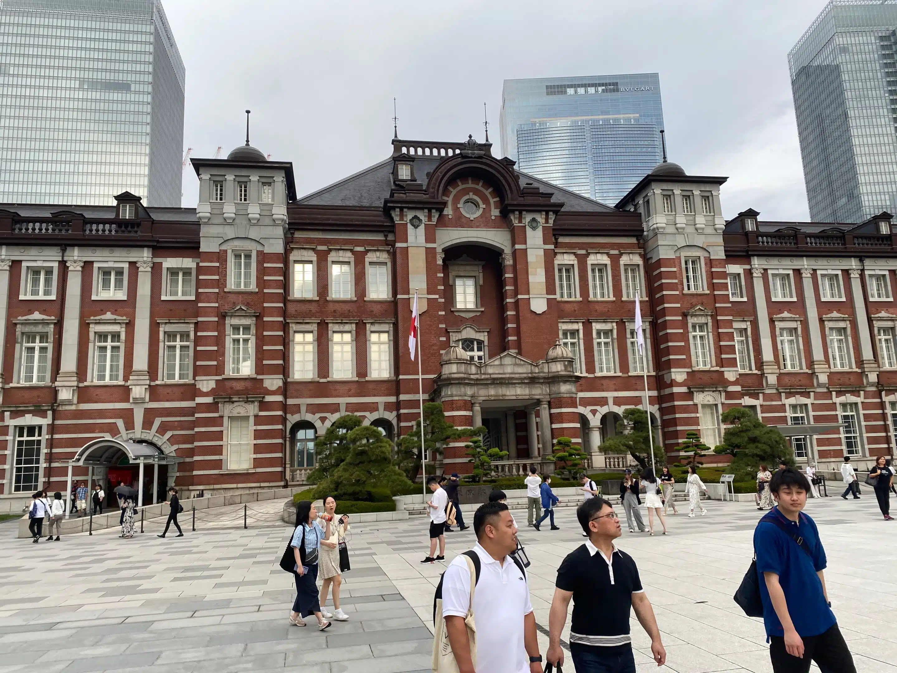 a group of people walking in front of a large building